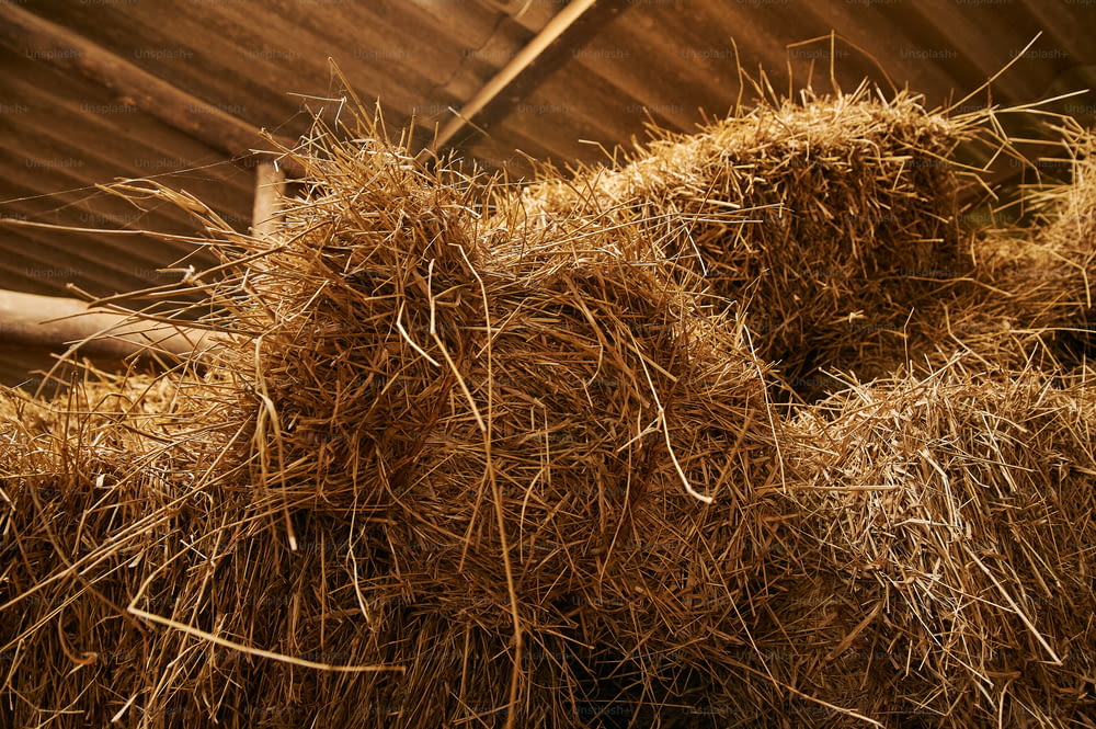 a pile of hay sitting on top of a wooden floor