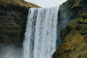 a large waterfall with water cascading down it's sides