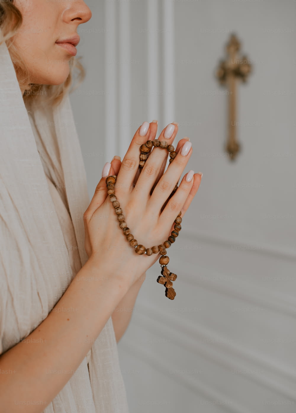 a woman holding a rosary in her hands