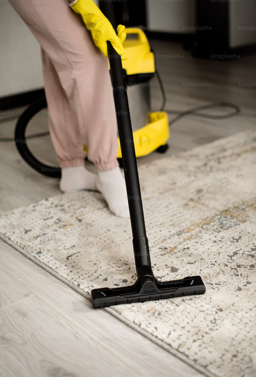 a person using a vacuum cleaner on the floor
