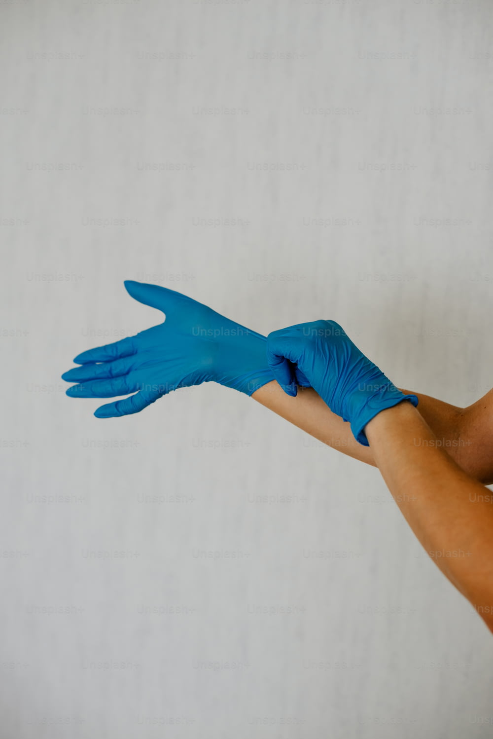 una persona con guantes azules en las manos