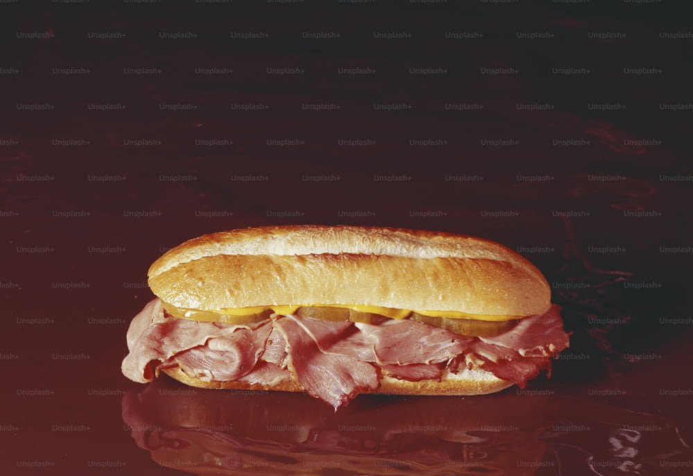 a sub sandwich with ham and cheese on a bun