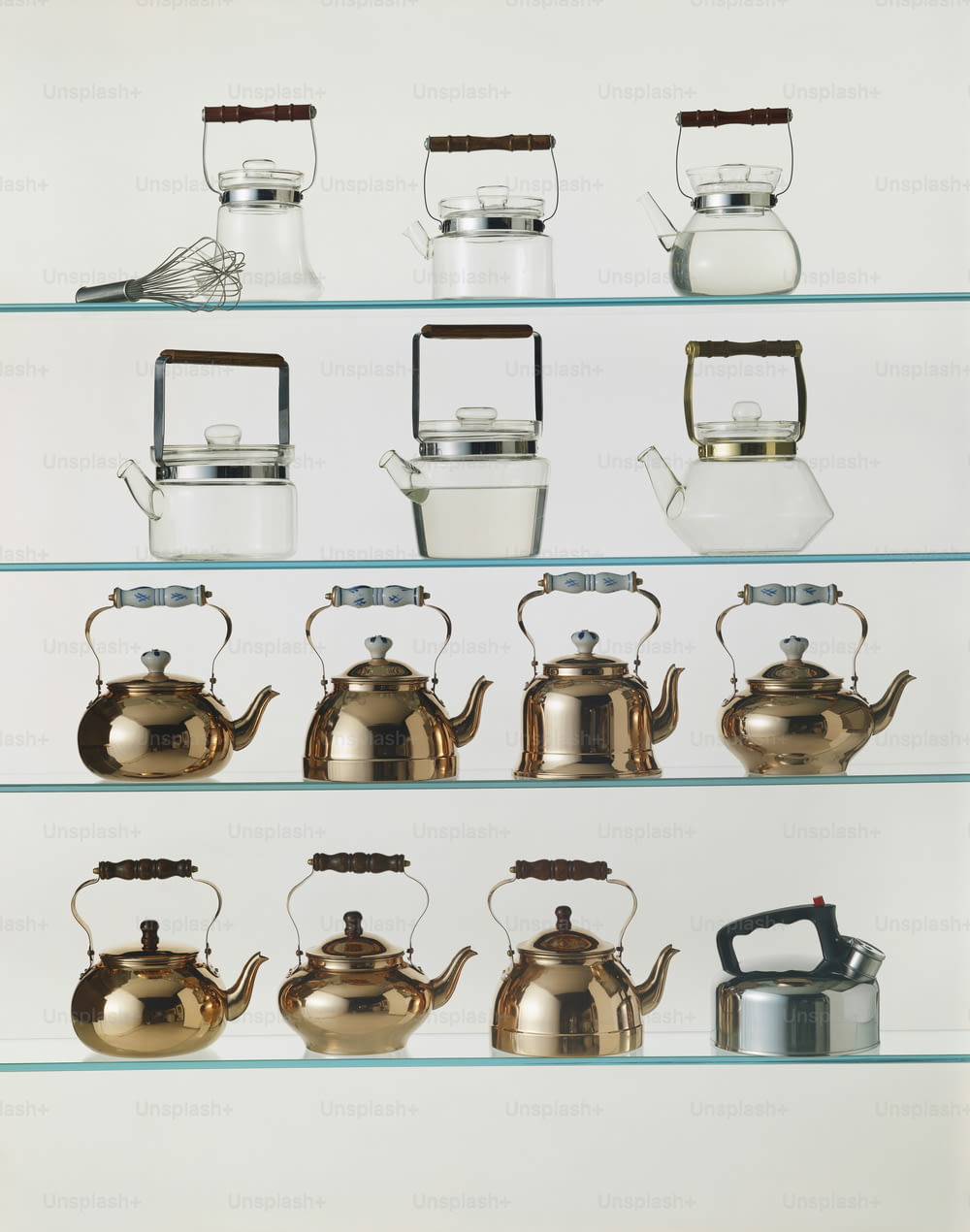 a shelf filled with lots of different types of kettles