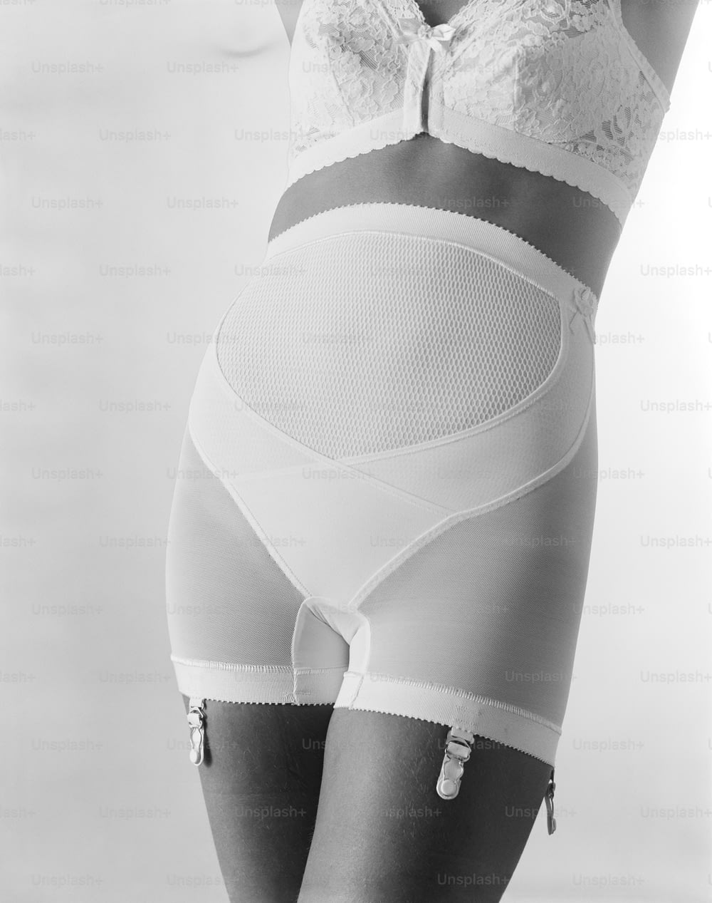 a black and white photo of a woman in underwear