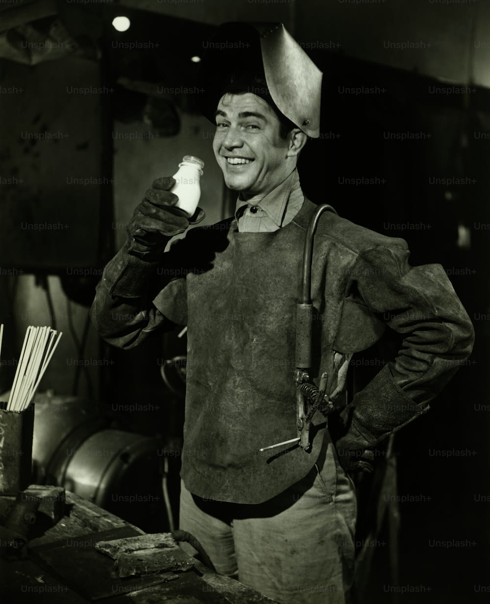 a black and white photo of a man holding a lighter