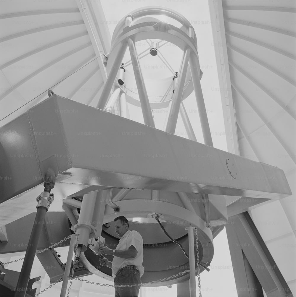 a man working on a large object in a building