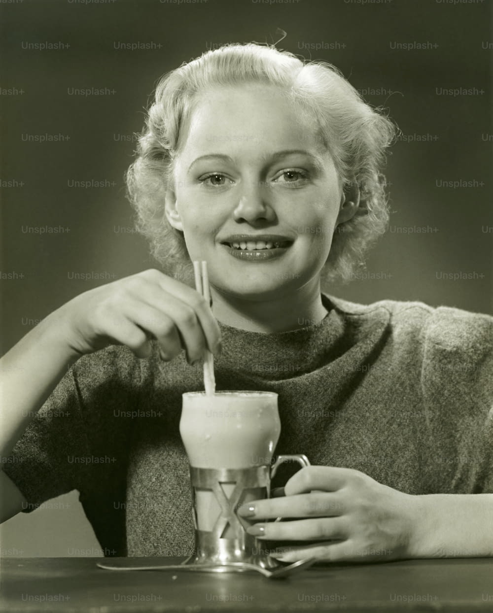 UNITED STATES - CIRCA 1950s:  Woman drinking ice cream soda.