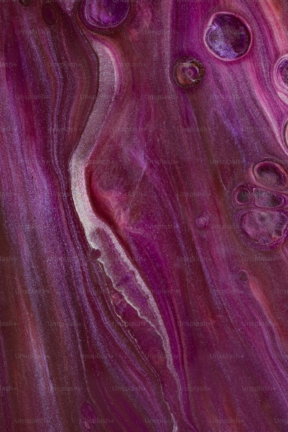 a close up of a purple and white marble