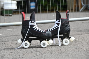 a pair of roller skates sitting on the ground