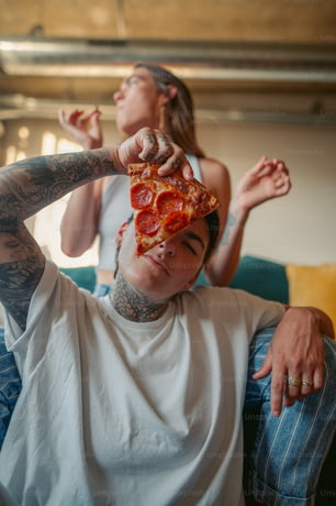 a man with a piece of pizza on his head