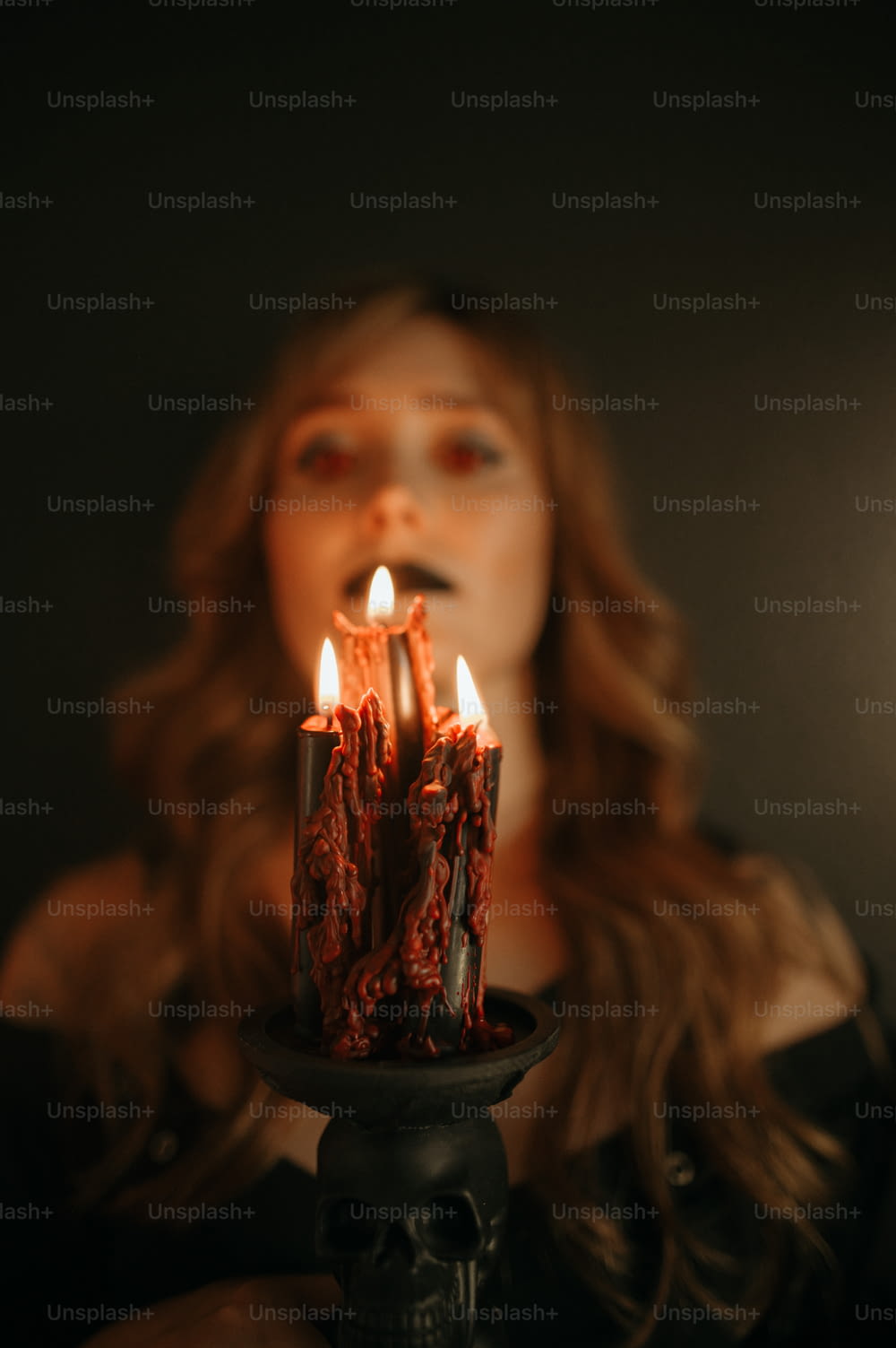 a woman holding a cake with candles in it