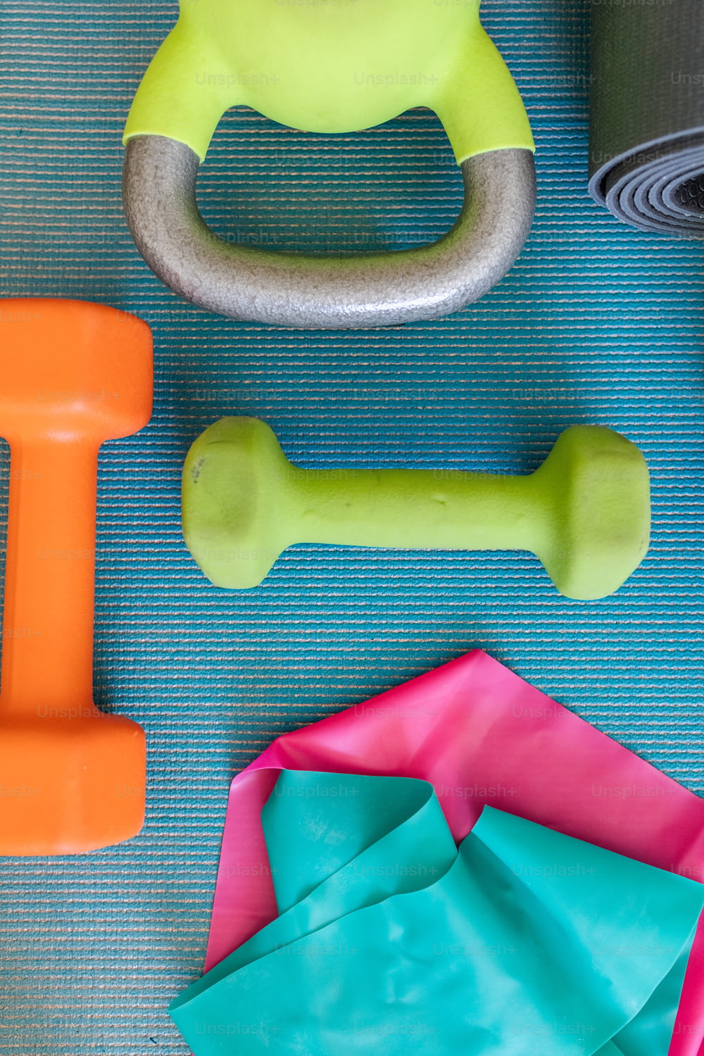 a variety of exercise equipment on a blue mat