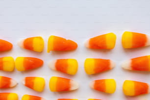 a group of orange and white candy candies