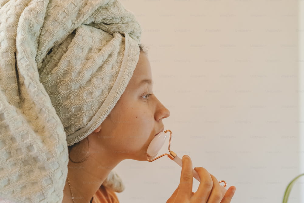 une femme avec une serviette enroulée autour de sa tête en train de manger quelque chose