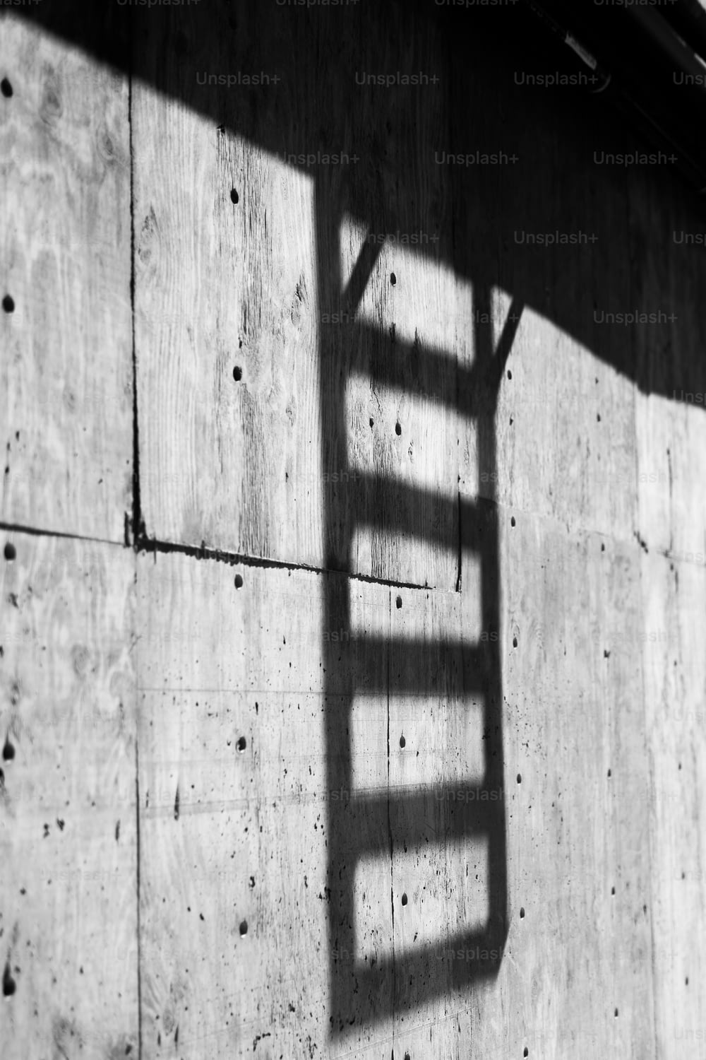 a shadow of a ladder on a wall