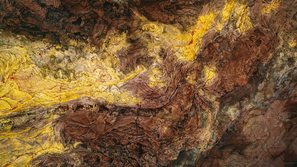 a painting of brown and yellow colors on a wall