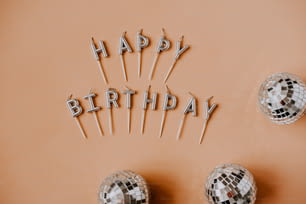 a happy birthday message made out of disco balls