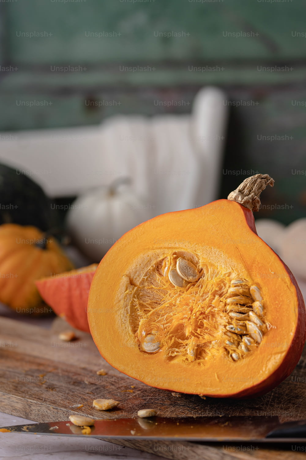 a cut up pumpkin sitting on top of a wooden cutting board