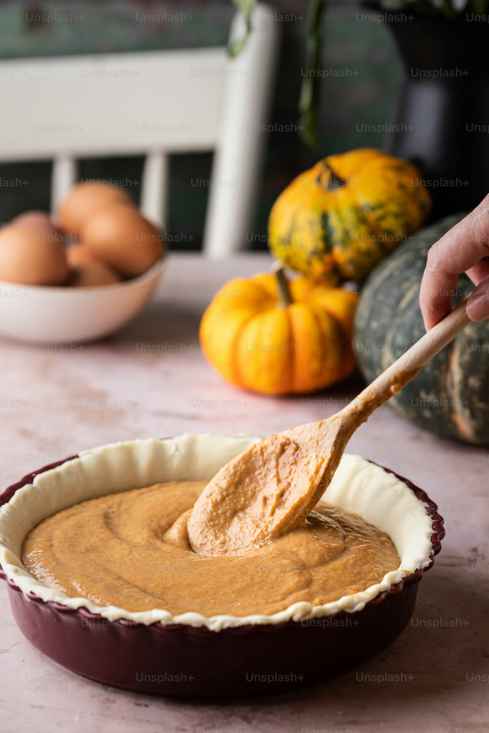 a wooden spoon in a pie pan filled with peanut butter