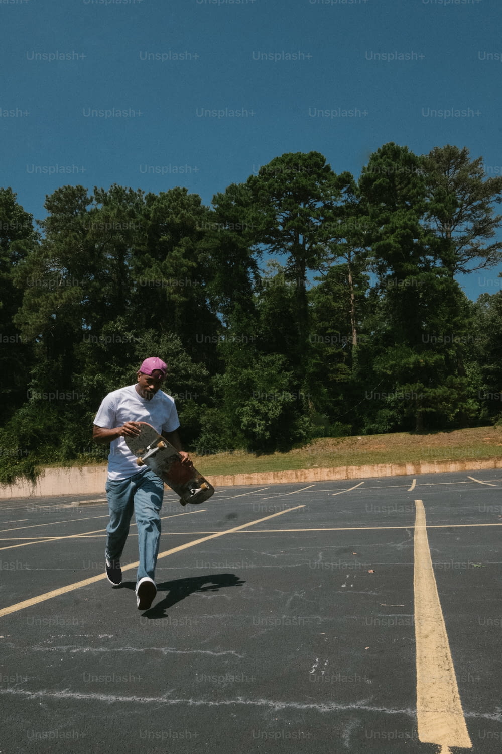 a man with a skateboard in a parking lot