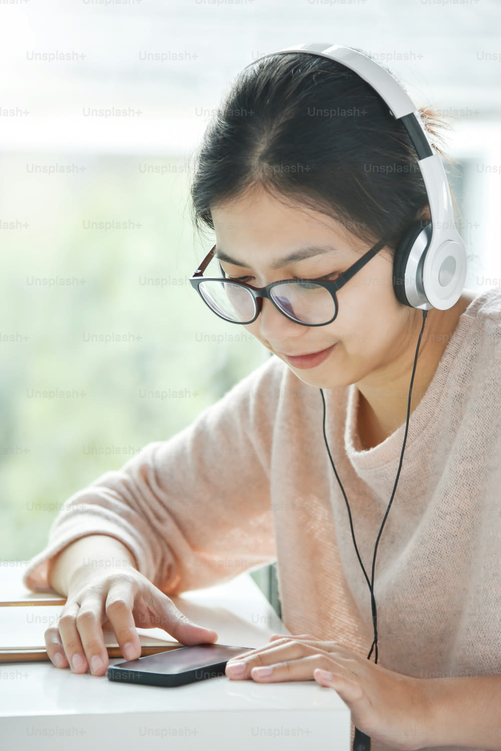 Happy Beautiful Asian woman listening to the music with headphone 