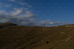 a hill with wind turbines on top of it
