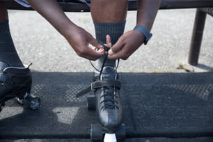 a person tying their shoes on a skateboard
