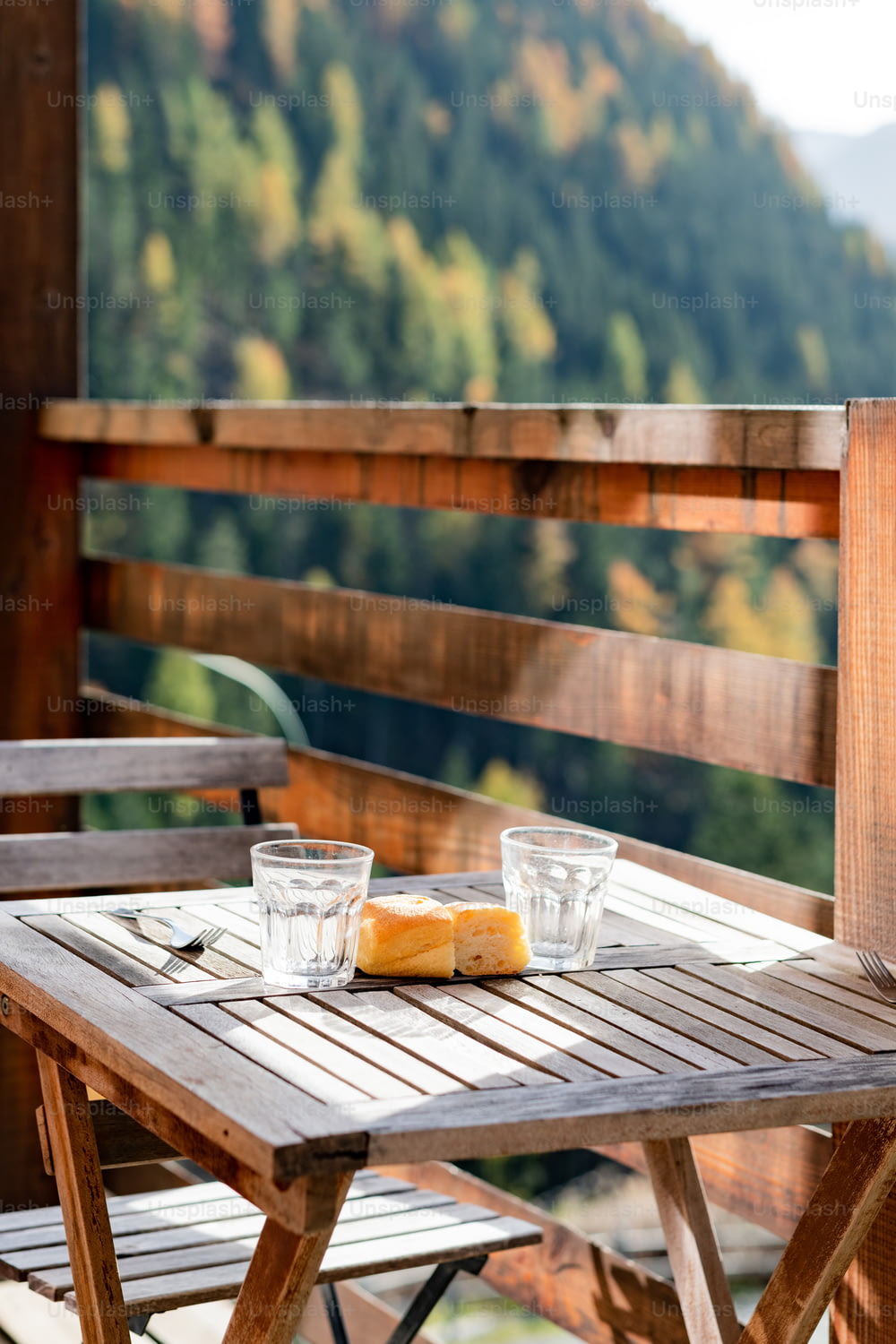 a wooden table with two glasses on top of it