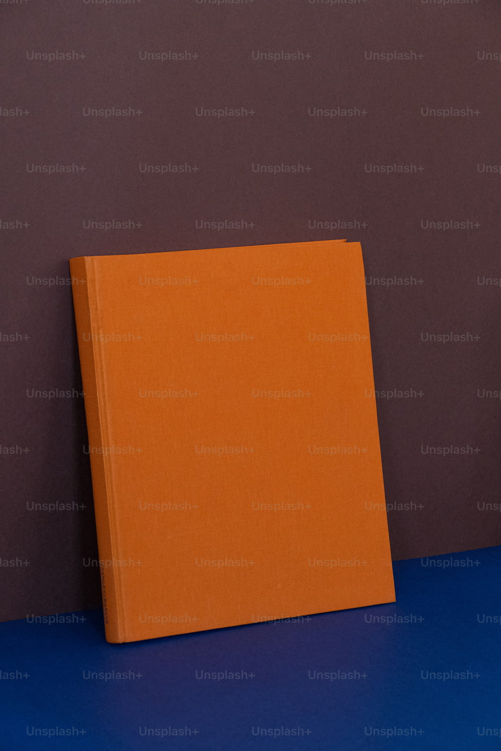 an orange book sitting on top of a blue table