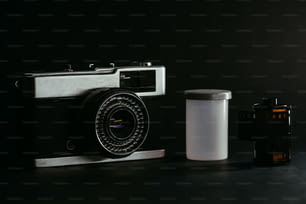 a camera and a container sitting on a table