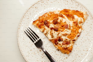 a slice of pizza on a plate with a fork