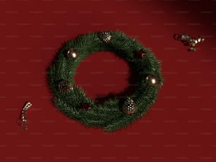 a christmas wreath with ornaments on a red background