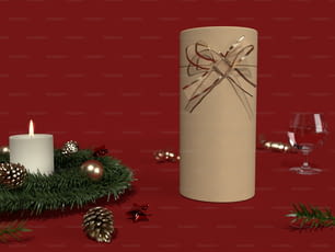 Una candela e alcune decorazioni natalizie su sfondo rosso
