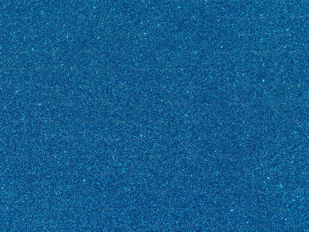 uno sfondo blu con una piccola quantità di glitter