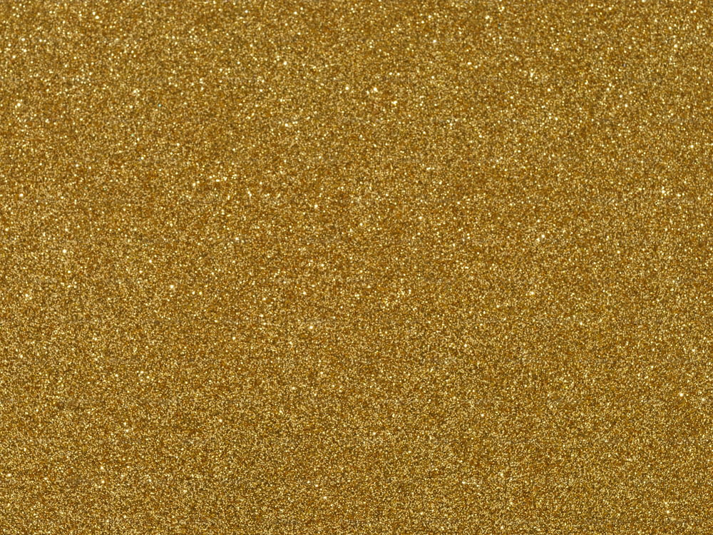 Un primo piano di uno sfondo glitter oro
