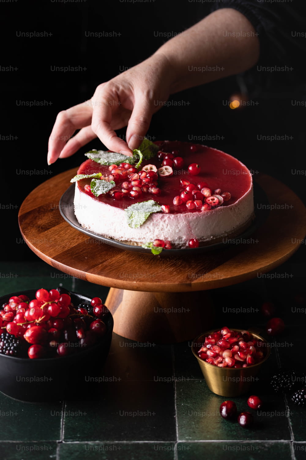 a person is decorating a cake with pomegranates