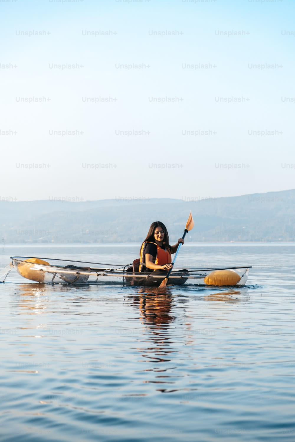 a woman in a canoe paddling on the water