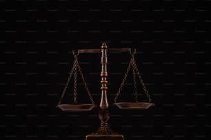 a wooden balance scale with a black background