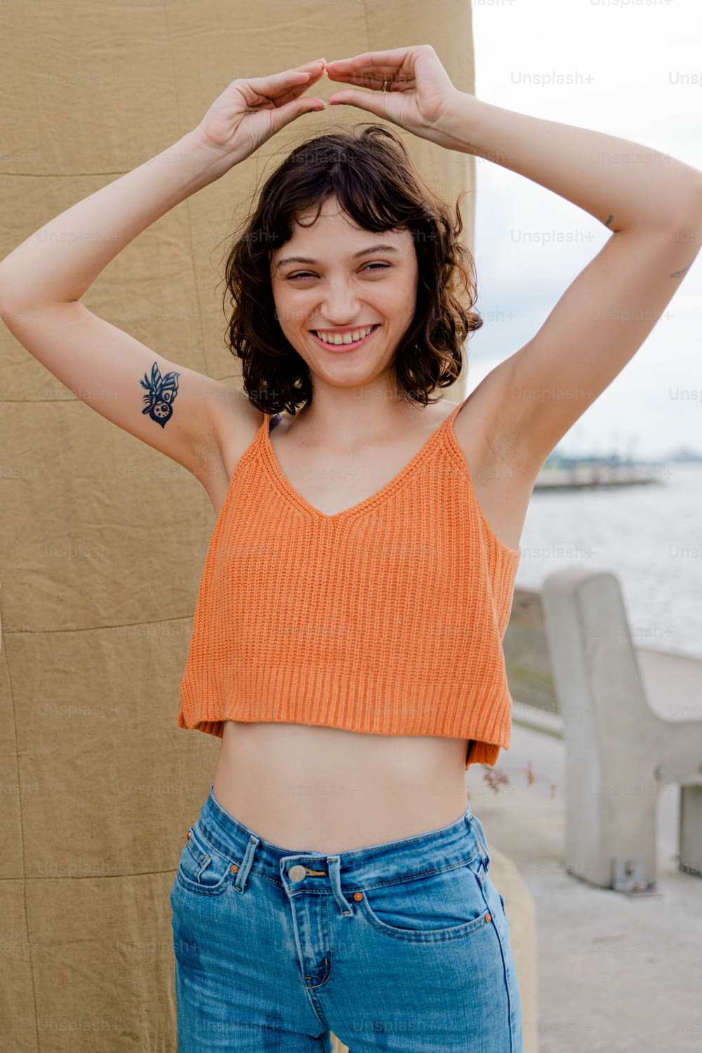 a woman in an orange crop top posing for a picture