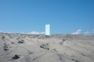 a blue square in the middle of a desert