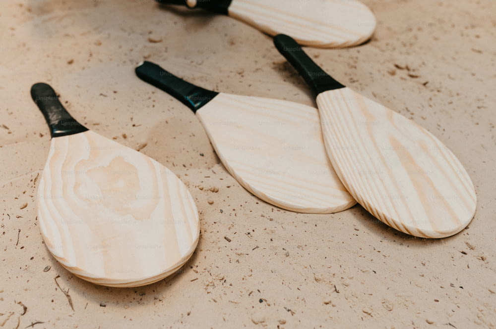 a group of wooden paddles sitting on top of a table