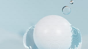 a white ball floating in the air next to a drop of water