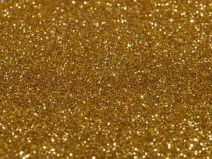 a close up of a gold glitter background