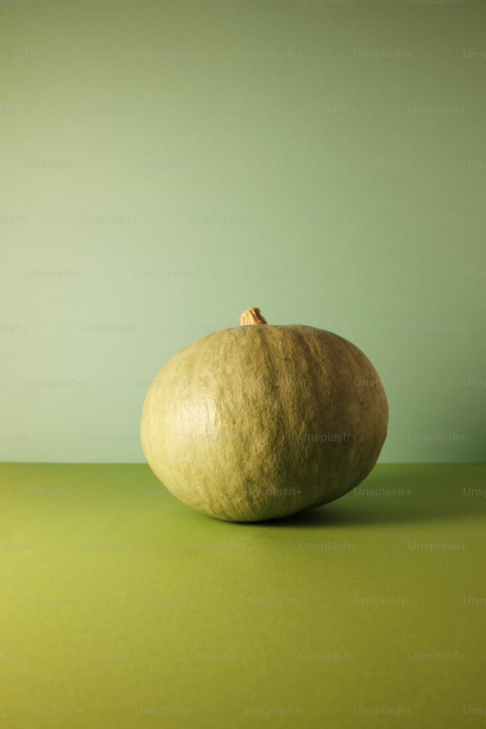 a piece of fruit sitting on top of a green table