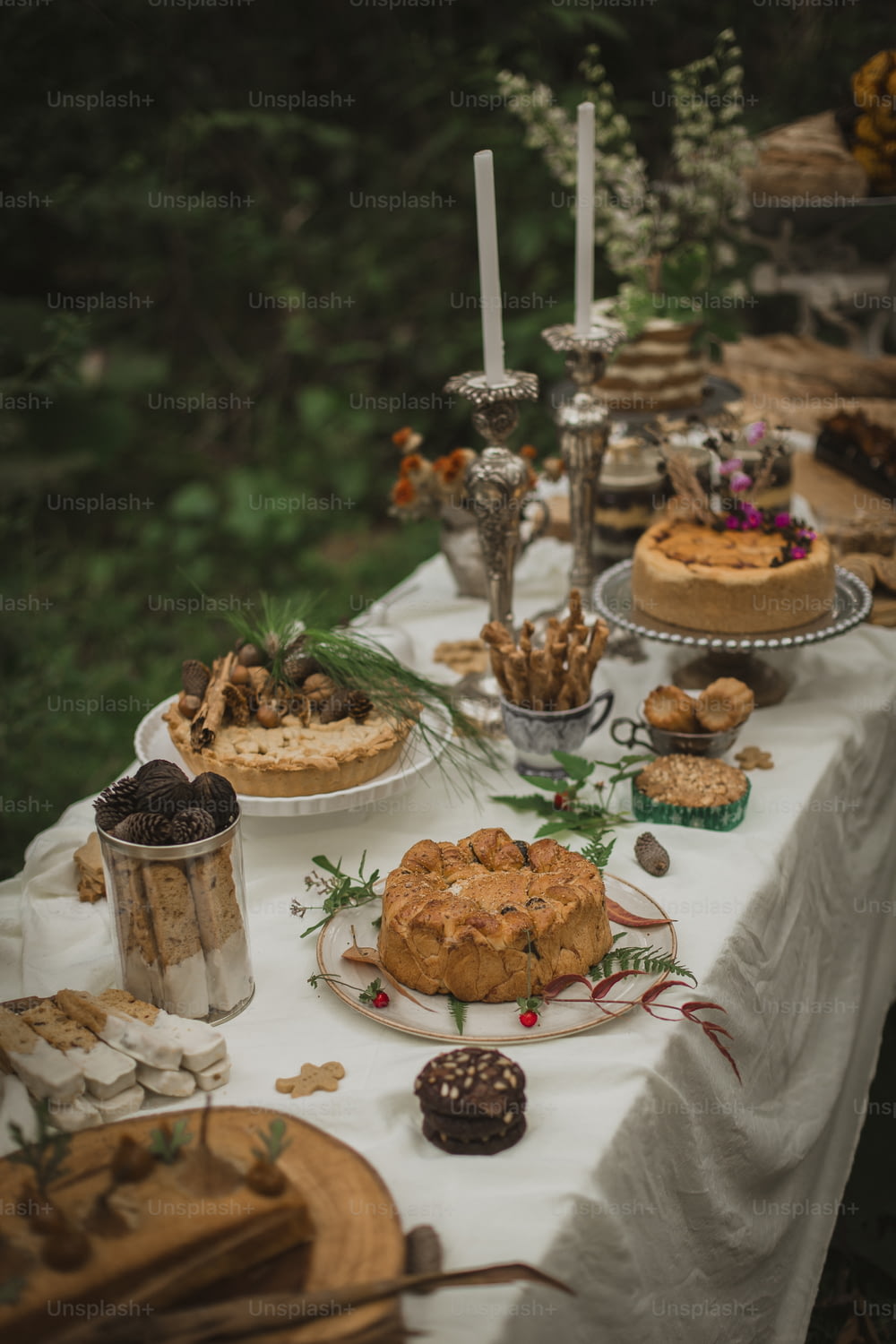 a table topped with lots of cakes and desserts