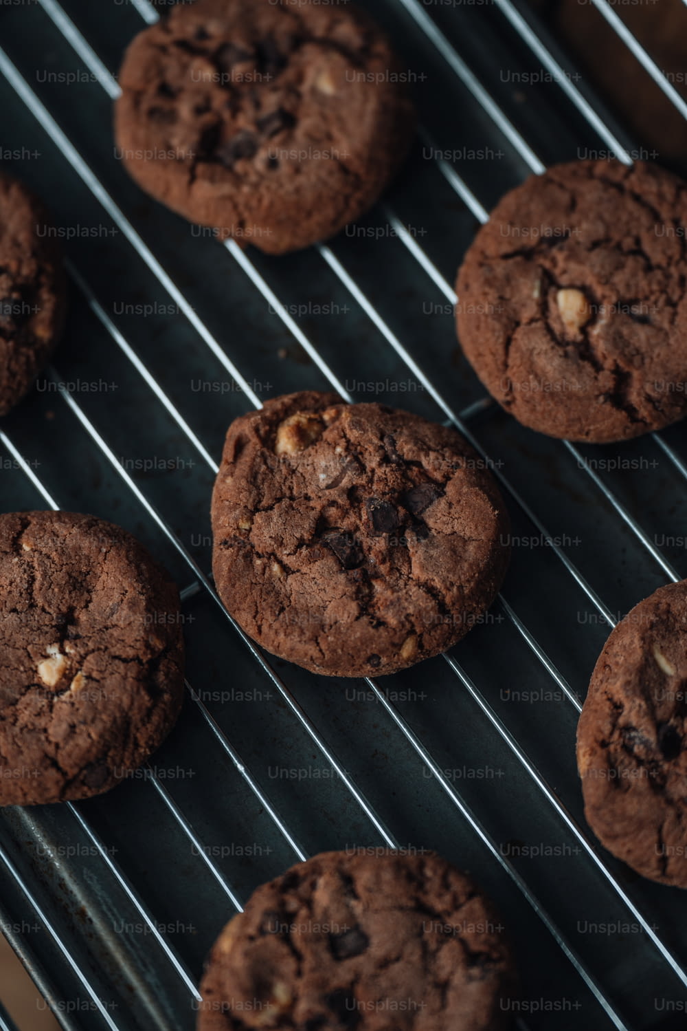 a close up of chocolate cookies on a cooling rack