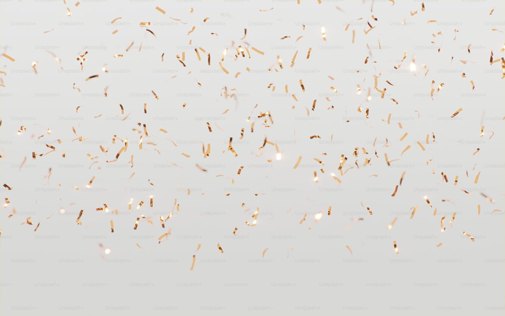 a lot of gold confetti on a white background