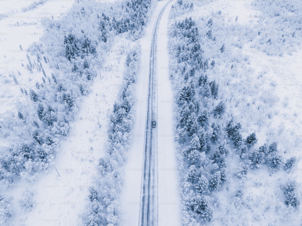 an aerial view of a snow covered road
