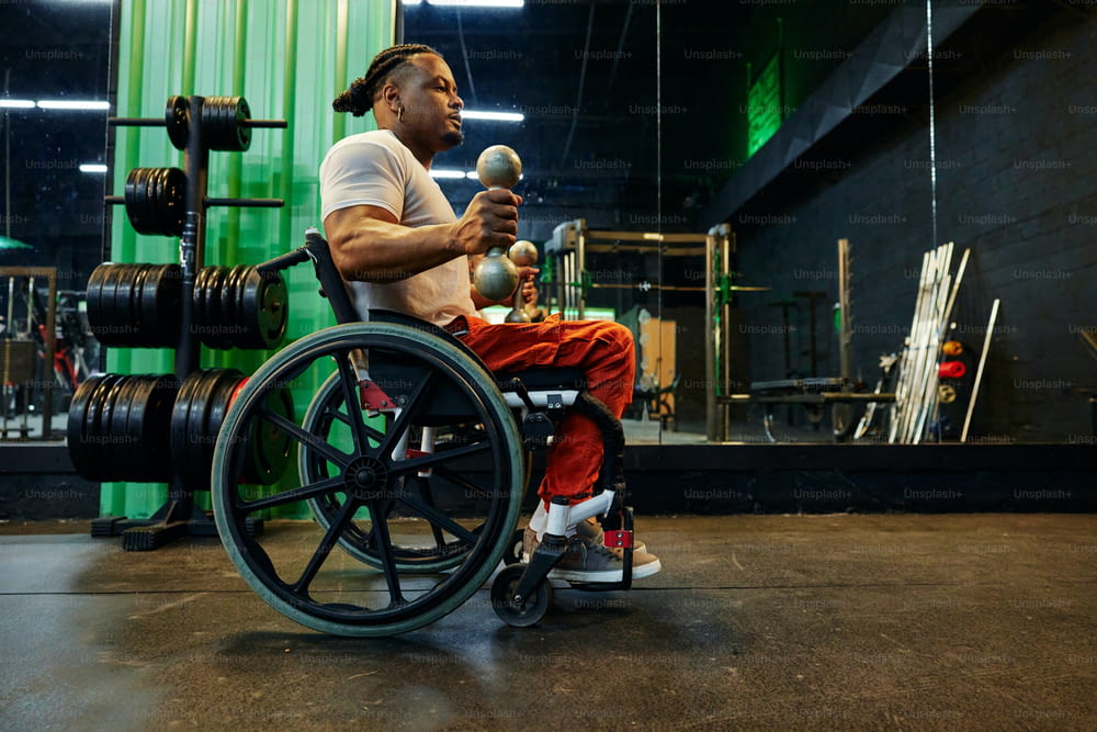 a woman sitting in a wheelchair with a man in a wheel chair