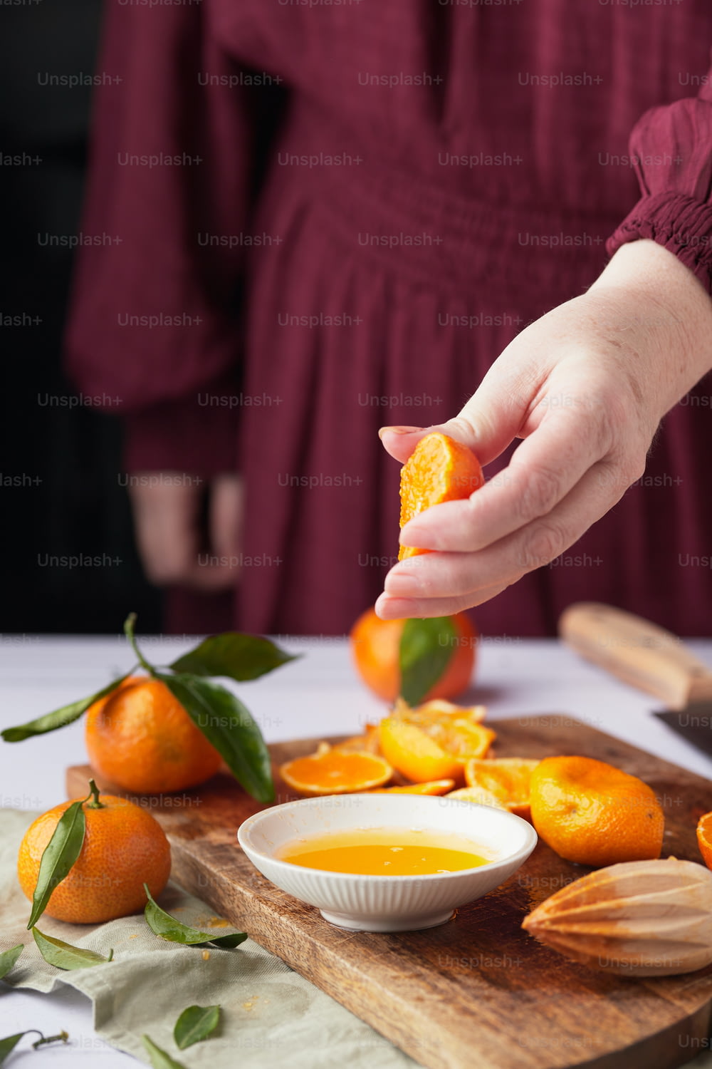 a person putting an orange in a bowl